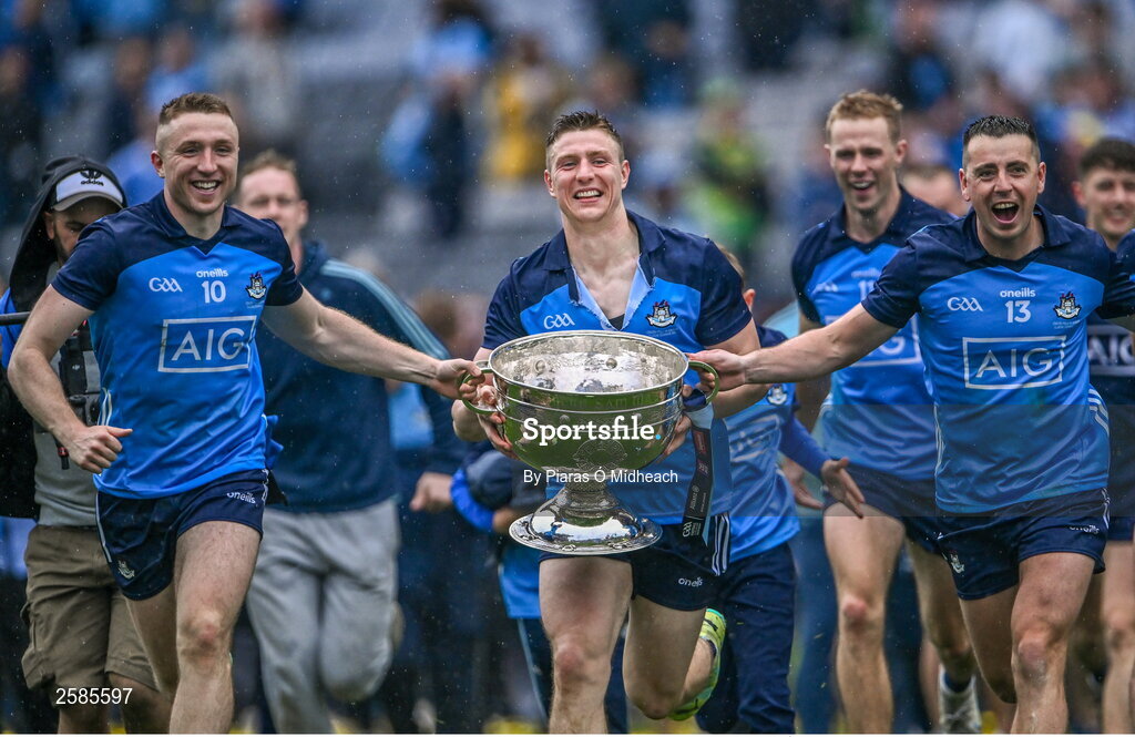 30 July 2023; Dublin players Paddy Small, 10, John Small and Cormac Costello, 13, celebrate with the Sam Maguire Cup after their side's victory in the GAA Football All-Ireland Senior Championship final match between Dublin and Kerry at Croke Park in Dublin. Photo by Piaras Ó Mídheach/Sportsfile