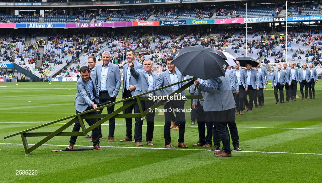 30 July 2023; Members of the 1998 All-Ireland winning Galway jubilee team attempt to dry the team bench before their squad picture before the GAA Football All-Ireland Senior Championship final match between Dublin and Kerry at Croke Park in Dublin. Photo by Piaras Ó Mídheach/Sportsfile