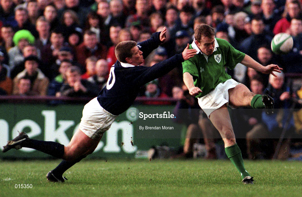 7 February 1998; Denis Hickie of Ireland kicks clear despite the tackle of Craig Chalmers of Scotland during the Five Nations Rugby Championship match between Ireland and Scotland at Lansdowne Road in Dublin, Ireland. Photo by Brendan Moran/Sportsfile