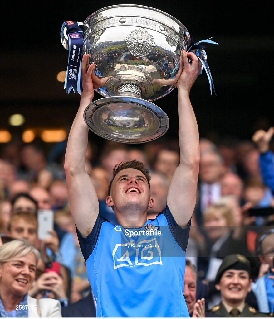 30 July 2023; Daire Newcombe of Dublin lifts the Sam Maguire Cup after the GAA Football All-Ireland Senior Championship final match between Dublin and Kerry at Croke Park in Dublin. Photo by Ramsey Cardy/Sportsfile