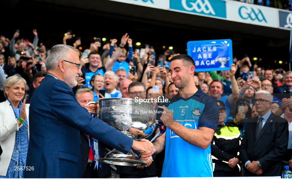 30 July 2023; Dublin captain James McCarthy is congratulated by Uachtarán Chumann Lúthchleas Gael Larry McCarthy as he presents him with the Sam Maguire Cup after the GAA Football All-Ireland Senior Championship final match between Dublin and Kerry at Croke Park in Dublin. Photo by Ray McManus/Sportsfile