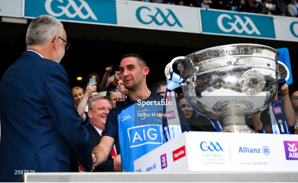 30 July 2023; Dublin captain James McCarthy is congratulated by Uachtarán Chumann Lúthchleas Gael Larry McCarthybbefore he presented him with the cup after the GAA Football All-Ireland Senior Championship final match between Dublin and Kerry at Croke Park in Dublin. Photo by Ray McManus/Sportsfile
