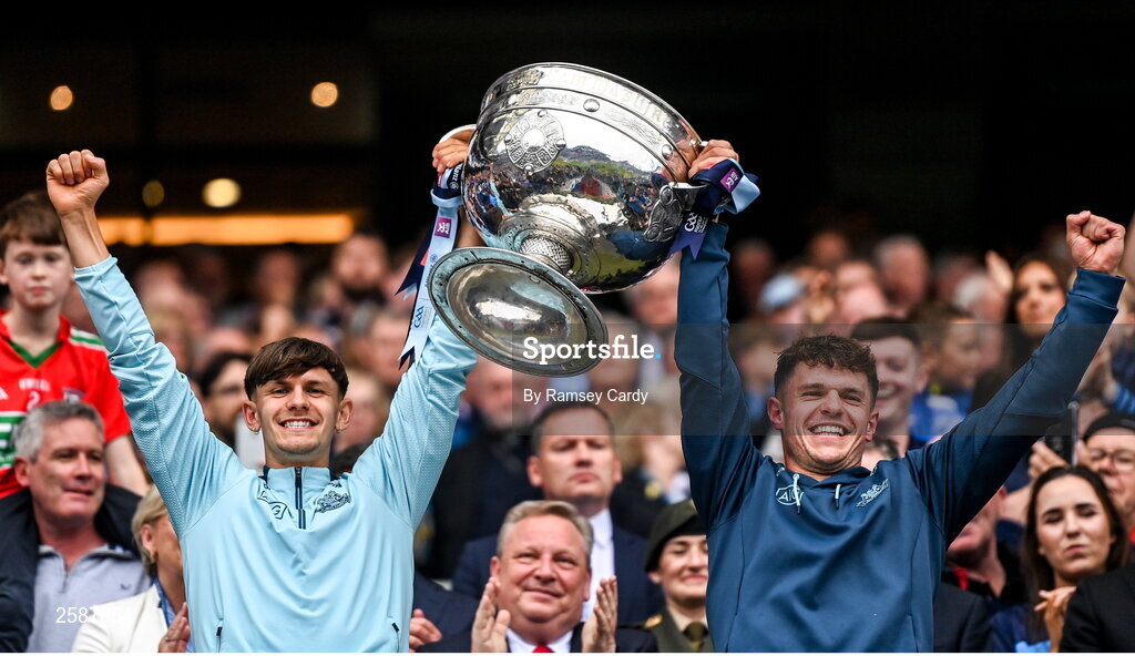 30 July 2023; Dublin players Ben Millist, left, and Liam Smith lift the Sam Maguire Cup after the GAA Football All-Ireland Senior Championship final match between Dublin and Kerry at Croke Park in Dublin. Photo by Ramsey Cardy/Sportsfile