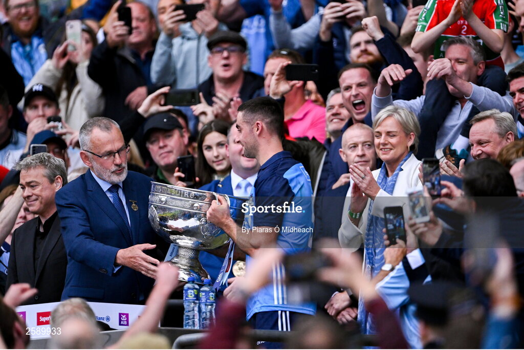 30 July 2023; Uachtarán Chumann Lúthchleas Gael Larry McCarthy presents the Sam Maguire Cup to Dublin captain James McCarthy after the GAA Football All-Ireland Senior Championship final match between Dublin and Kerry at Croke Park in Dublin. Photo by Piaras Ó Mídheach/Sportsfile