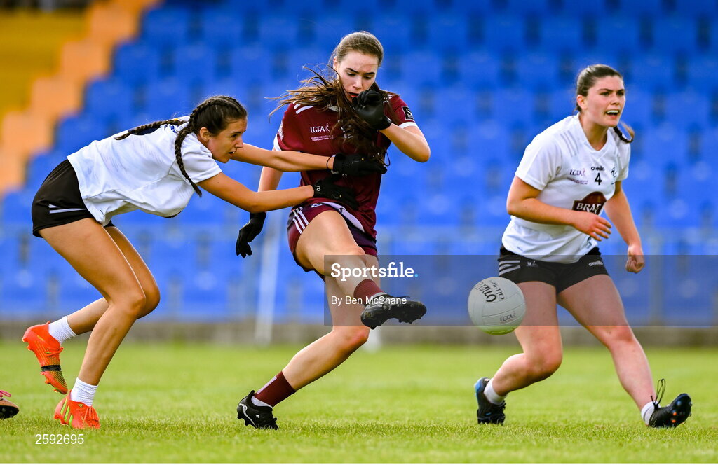 5 August 2023; Aisling Madden of Galway scores her side's first goal despite the tackle of Julie Brannigan of Kildare during the ZuCar All-Ireland Ladies Football U18 A final match between Galway and Kildare at Glennon Brothers Pearse Park in Longford. Photo by Ben McShane/Sportsfile