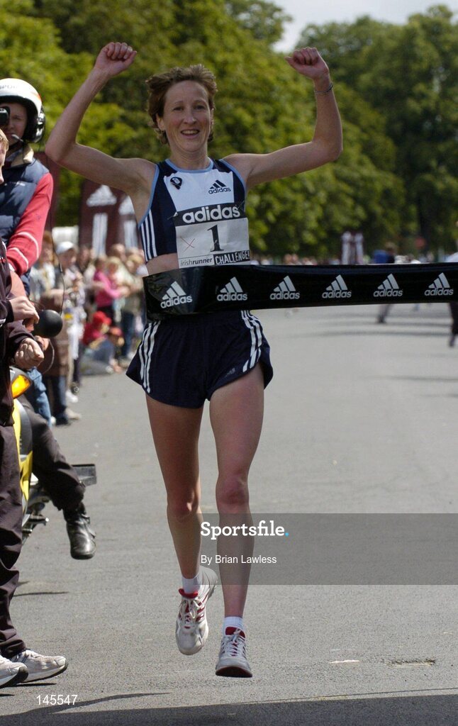 4 July 2004; Catherina McKiernan crosses the finish line to be the first woman home, in a time of 00:26:14, in the adidas Irish Runner Challenge, Phoenix Park, Dublin. Picture credit; Brian Lawless / SPORTSFILE