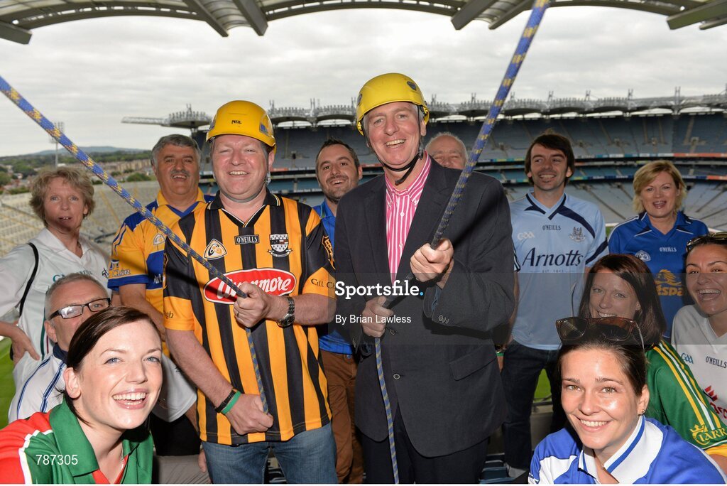 28 August 2013; The Sunday Game Presenter Michael Lyster was joined today in Croke Park by motor neurone disease (MND) sufferer Paul Lannon and friends sporting their county colours to encourage others from across Ireland to abseil 100ft off the Hogan Stand in aid of the Irish Motor Neurone Disease Association (IMNDA). At the event is Michael Lyster, Paul Lannon, from Knocktopher, Co. Kilkenny, and GAA supporters. Croke Park, Dublin. Picture credit: Brian Lawless / SPORTSFILE
