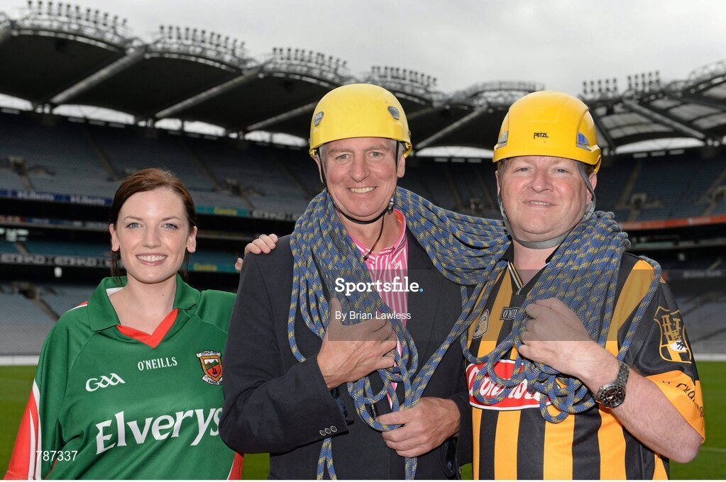 28 August 2013; The Sunday Game Presenter Michael Lyster was joined today in Croke Park by motor neurone disease (MND) sufferer Paul Lannon and friends sporting their county colours to encourage others from across Ireland to abseil 100ft off the Hogan Stand in aid of the Irish Motor Neurone Disease Association (IMNDA). At the event is Michael Lyster and Paul Lannon, from Knocktopher, Co. Kilkenny, Mayo supporter Pauline Egan, from Kilkelly, Co. Mayo. Croke Park, Dublin. Picture credit: Brian Lawless / SPORTSFILE