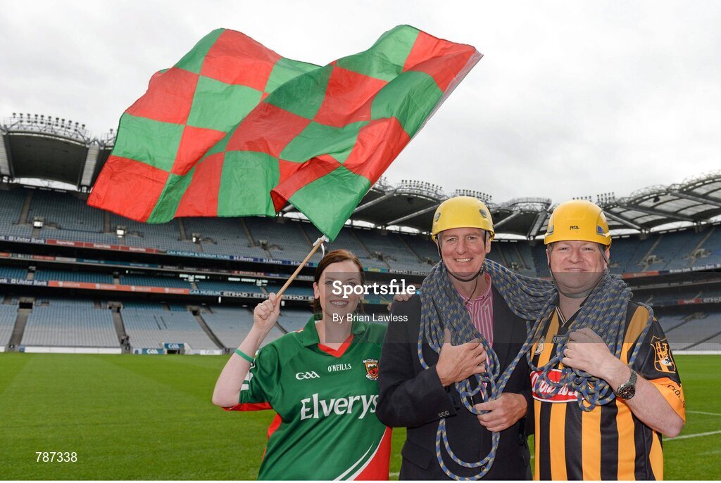 28 August 2013; The Sunday Game Presenter Michael Lyster was joined today in Croke Park by motor neurone disease (MND) sufferer Paul Lannon and friends sporting their county colours to encourage others from across Ireland to abseil 100ft off the Hogan Stand in aid of the Irish Motor Neurone Disease Association (IMNDA). At the event is Michael Lyster and Paul Lannon, from Knocktopher, Co. Kilkenny, Mayo supporter Pauline Egan, from Kilkelly, Co. Mayo. Croke Park, Dublin. Picture credit: Brian Lawless / SPORTSFILE
