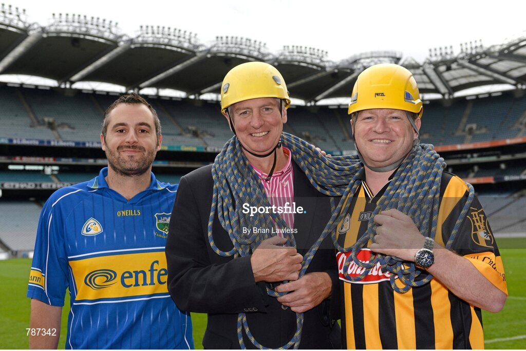 28 August 2013; The Sunday Game Presenter Michael Lyster was joined today in Croke Park by motor neurone disease (MND) sufferer Paul Lannon and friends sporting their county colours to encourage others from across Ireland to abseil 100ft off the Hogan Stand in aid of the Irish Motor Neurone Disease Association (IMNDA). At the event is Michael Lyster and Paul Lannon, from Knocktopher, Co. Kilkenny, with Tipperary supporter Evan Farrell. Croke Park, Dublin. Picture credit: Brian Lawless / SPORTSFILE