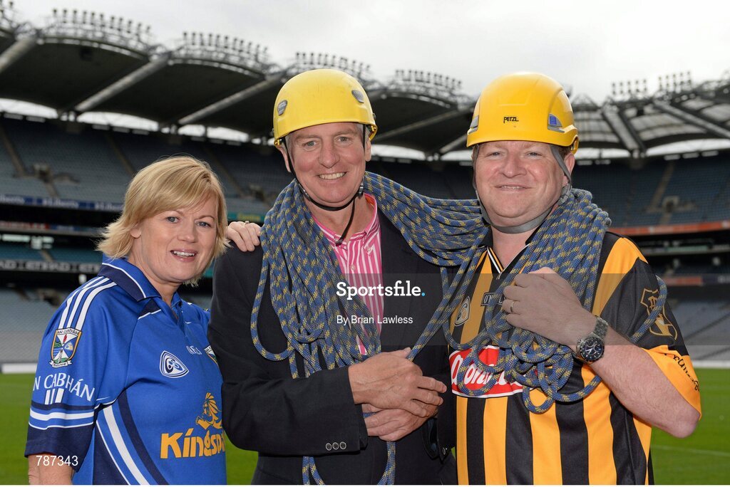 28 August 2013; The Sunday Game Presenter Michael Lyster was joined today in Croke Park by motor neurone disease (MND) sufferer Paul Lannon and friends sporting their county colours to encourage others from across Ireland to abseil 100ft off the Hogan Stand in aid of the Irish Motor Neurone Disease Association (IMNDA). At the event is Michael Lyster and Paul Lannon, from Knocktopher, Co. Kilkenny, with Cavan supporter Mary Reavey, from Kingscourt, Co. Cavan. Croke Park, Dublin. Picture credit: Brian Lawless / SPORTSFILE