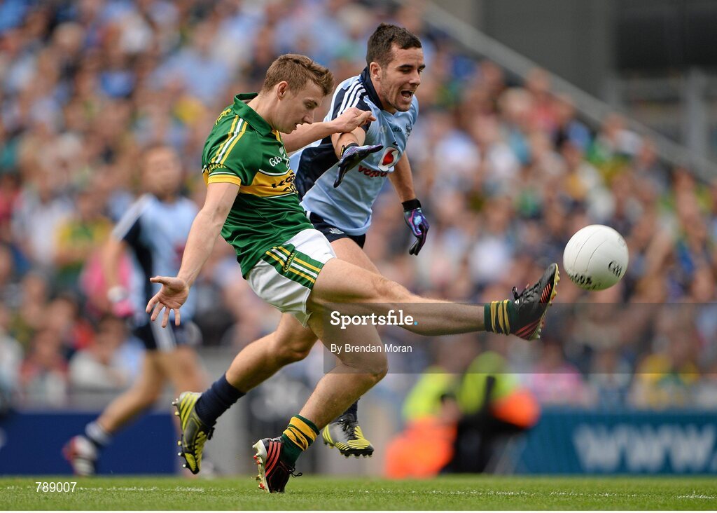 1 September 2013; James O'Donoghue, Kerry, kicks a point despite the best efforts of Kevin O'Brien, Dublin. GAA Football All-Ireland Senior Championship, Semi-Final, Dublin v Kerry, Croke Park, Dublin. Picture credit: Brendan Moran / SPORTSFILE