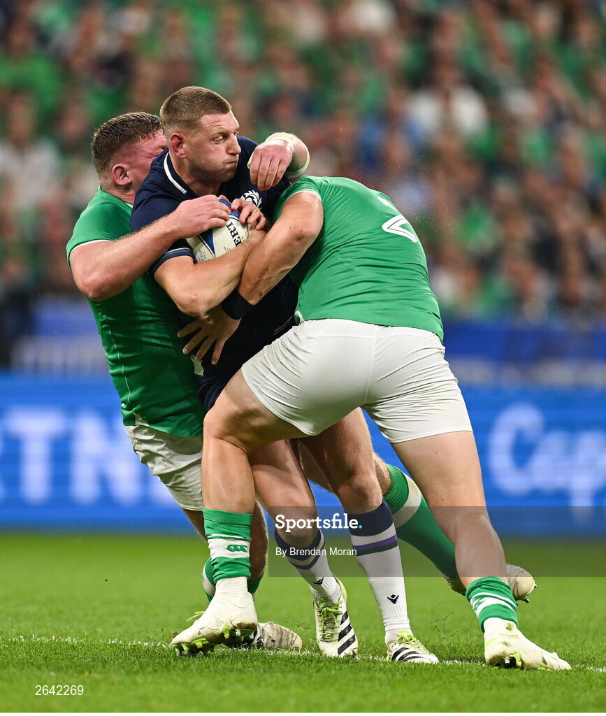 7 October 2023; Finn Russell of Scotland is tackled by Ireland players Tadhg Furlong, left, and Dan Sheehan during the 2023 Rugby World Cup Pool B match between Ireland and Scotland at the Stade de France in Paris, France. Photo by Brendan Moran/Sportsfile