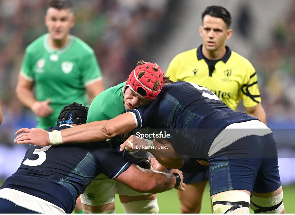 7 October 2023; Josh van der Flier of Ireland is tackled by Scotland players Zander Fagerson, left, and Grant Gilchrist during the 2023 Rugby World Cup Pool B match between Ireland and Scotland at the Stade de France in Paris, France. Photo by Ramsey Cardy/Sportsfile