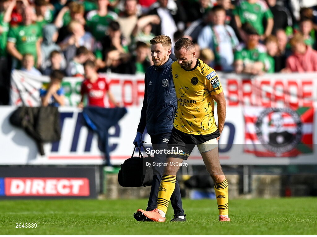 8 October 2023; Ryan McLoughlin of St Patrick's Athletic leaves the pitch to receive medical attention with St Patrick's Athletic head of medical Sam Rice during the Sports Direct Men’s FAI Cup semi-final match between Cork City and St Patrick's Athletic at Turner’s Cross in Cork. Photo by Stephen McCarthy/Sportsfile