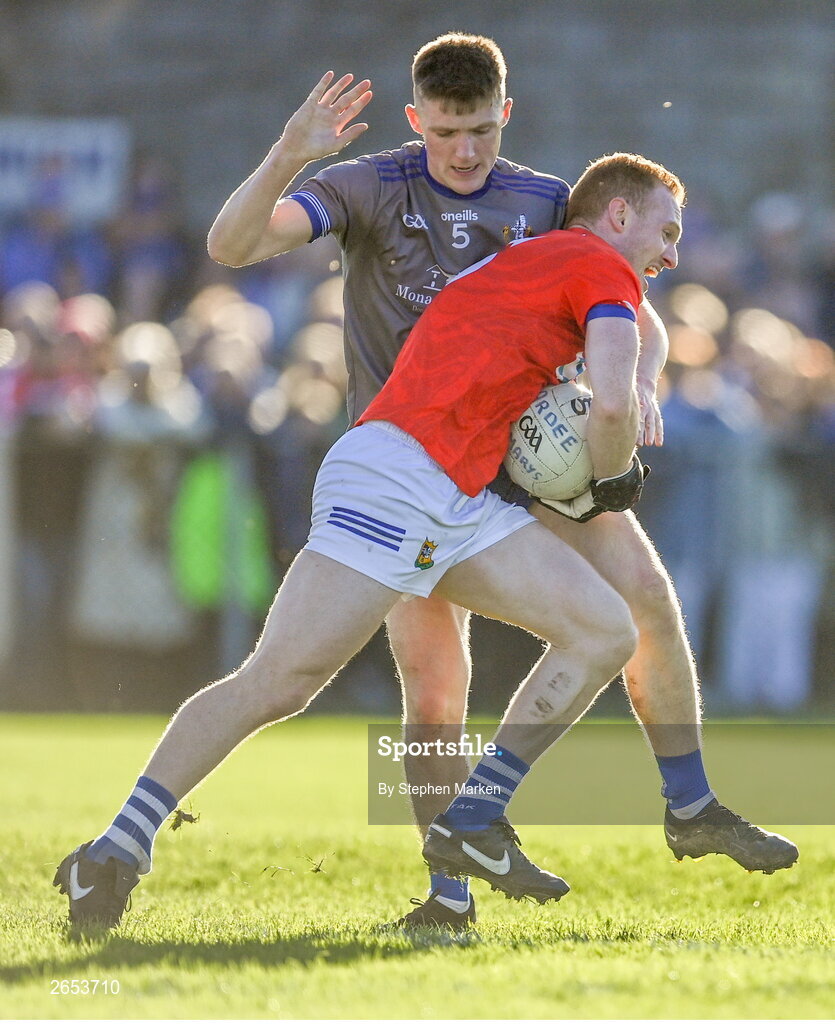 22 October 2023; Donal McKenny of Ardee St Mary's is tackled by Evan Whelan of Naomh Mairtin during the Louth County Senior Club Football Championship final between Ardee St Mary's and Naomh Mairtin at Pairc Naomh Bríd in Dowdallshill, Louth. Photo by Stephen Marken/Sportsfile