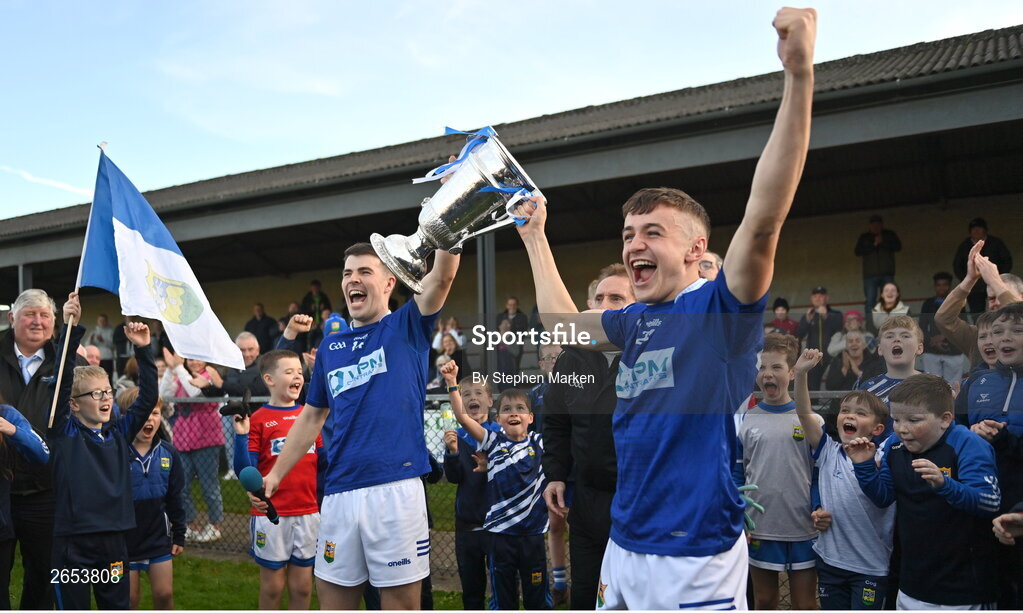 22 October 2023; Ardee St Mary's captain Dáire McConnon and Tadhg McDonnell lift the Joe Ward Cup after the Louth County Senior Club Football Championship final between Ardee St Mary's and Naomh Mairtin at Pairc Naomh Bríd in Dowdallshill, Louth. Photo by Stephen Marken/Sportsfile