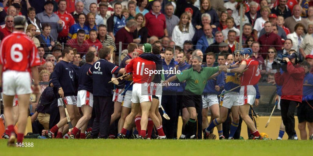 10 July 2004; Linesman Pat Horan attempts to separate players and officials from both Cork and Tipperary. Guinness Senior Hurling Championship Qualifier, Round 3, Cork v Tipperary, Fitzgerald Stadium, Killarney, Co. Kerry. Picture credit; Brendan Moran / SPORTSFILE