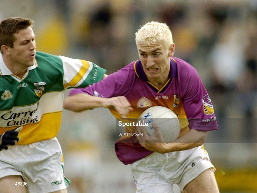 10 July 2004; Redmond Barry, Wexford, is tackled by Karol Slattery, Offaly. Bank of Ireland Senior Football Championship Qualifier, Round 2, Wexford v Offaly, Wexford Park, Wexford. Picture credit; Matt Browne / SPORTSFILE