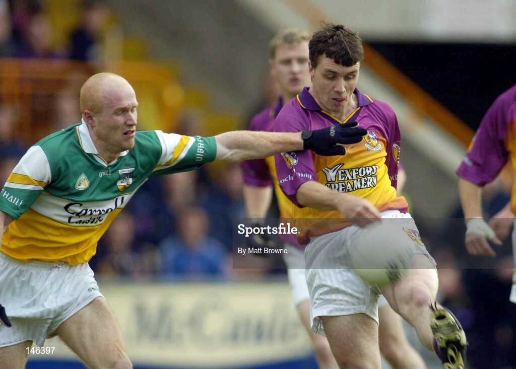 10 July 2004; Jason Lawlor, Wexford, is tackled by Conor Evans, Offaly. Bank of Ireland Senior Football Championship Qualifier, Round 2, Wexford v Offaly, Wexford Park, Wexford. Picture credit; Matt Browne / SPORTSFILE