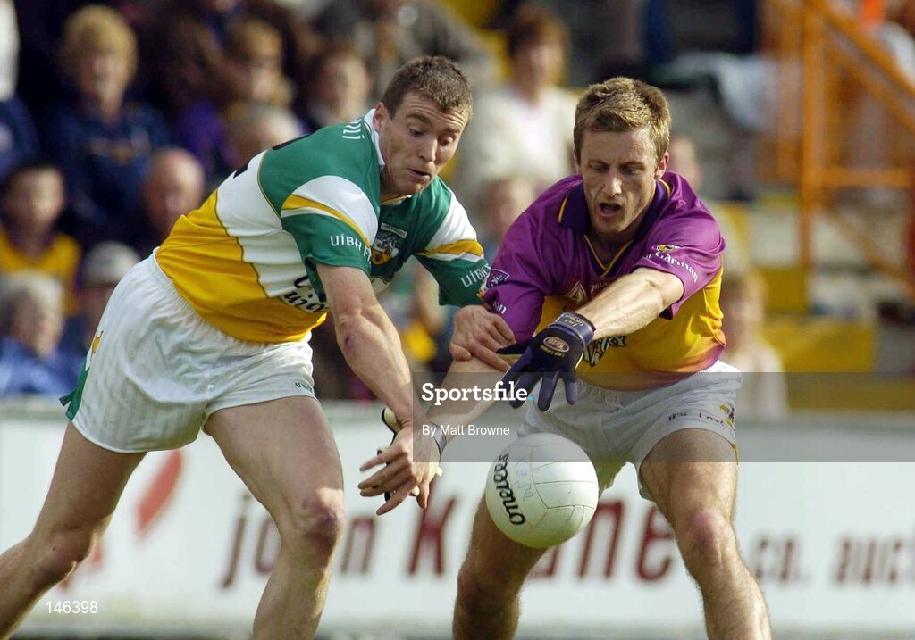 10 July 2004; David Fogarty, Wexford, is tackled by Ciaran McManus, Offaly. Bank of Ireland Senior Football Championship Qualifier, Round 2, Wexford v Offaly, Wexford Park, Wexford. Picture credit; Matt Browne / SPORTSFILE