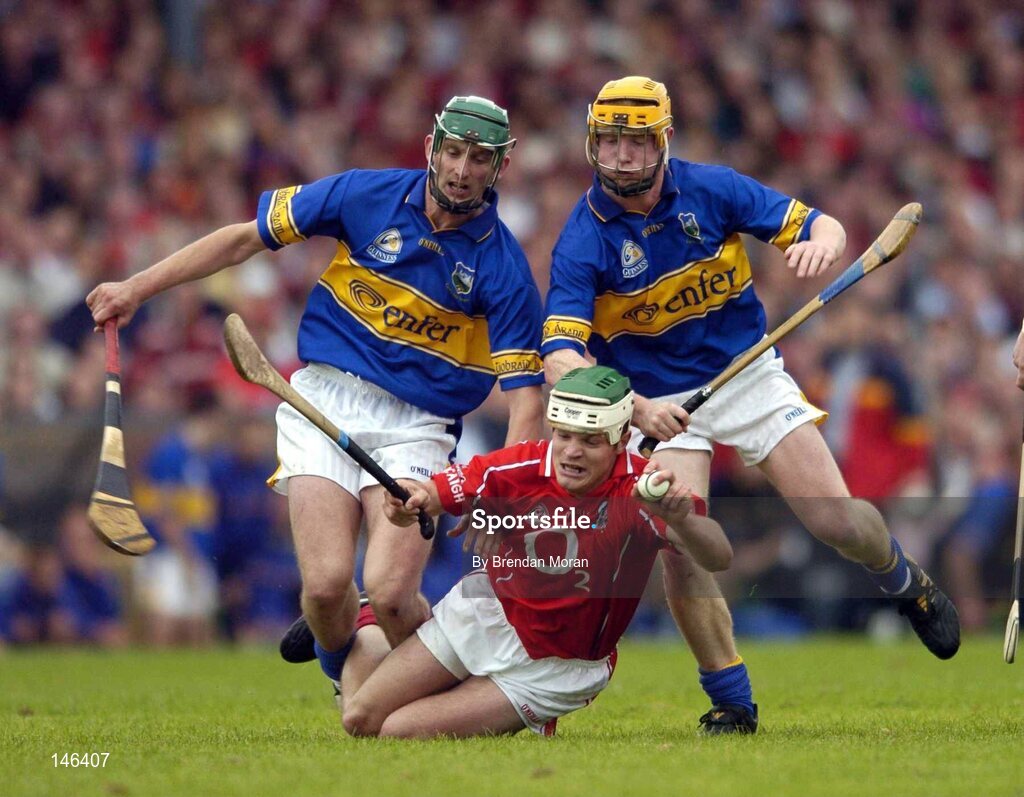 10 July 2004; Niall McCarthy, Cork, in action against Declan Fanning, left, and Eamonn Corcoran, Tipperary. Guinness Senior Hurling Championship Qualifier, Round 3, Cork v Tipperary, Fitzgerald Stadium, Killarney, Co. Kerry. Picture credit; Brendan Moran / SPORTSFILE