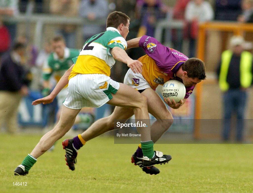 10 July 2004; Darragh Breen, Wexford, is tackled by Ciaran McManus, Offaly. Bank of Ireland Senior Football Championship Qualifier, Round 2, Wexford v Offaly, Wexford Park, Wexford. Picture credit; Matt Browne / SPORTSFILE