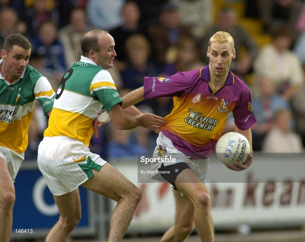 10 July 2004; Matty Forde, Wexford, is tackled by Mark Daly, Offaly. Bank of Ireland Senior Football Championship Qualifier, Round 2, Wexford v Offaly, Wexford Park, Wexford. Picture credit; Matt Browne / SPORTSFILE