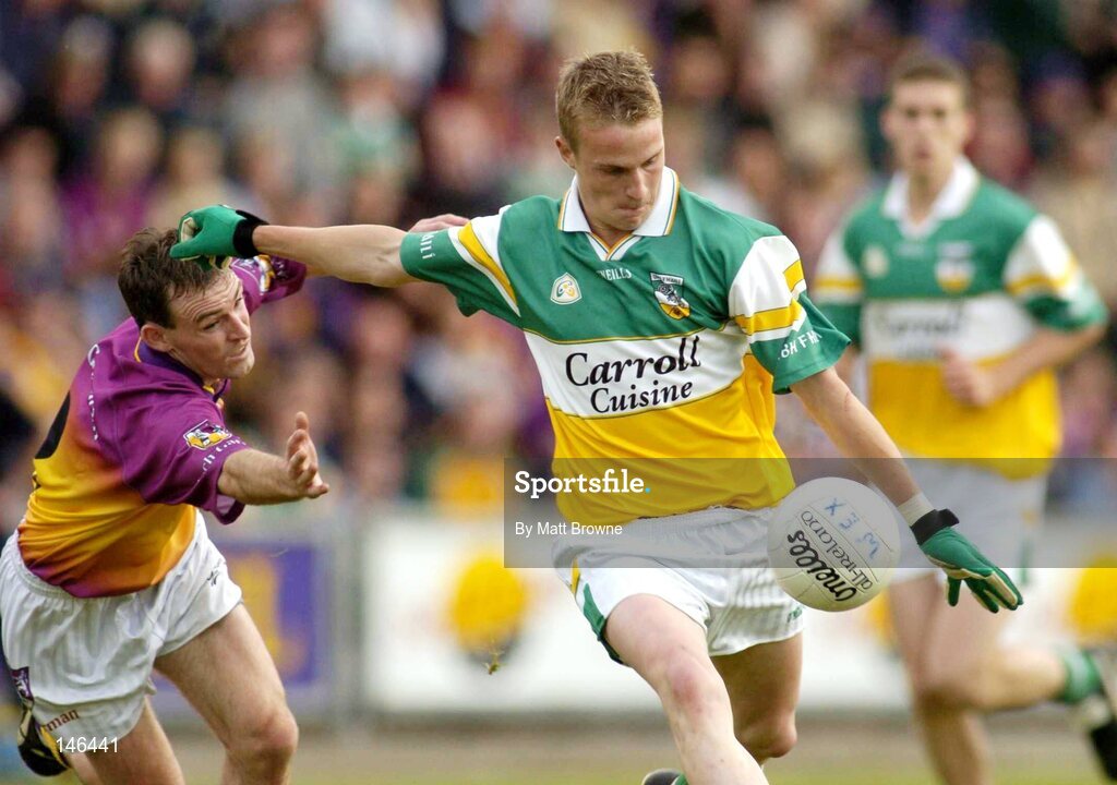 10 July 2004; James Coughlan, Offaly, is tackled by Colm Morris, Wexford. Bank of Ireland Senior Football Championship Qualifier, Round 2, Wexford v Offaly, Wexford Park, Wexford. Picture credit; Matt Browne / SPORTSFILE