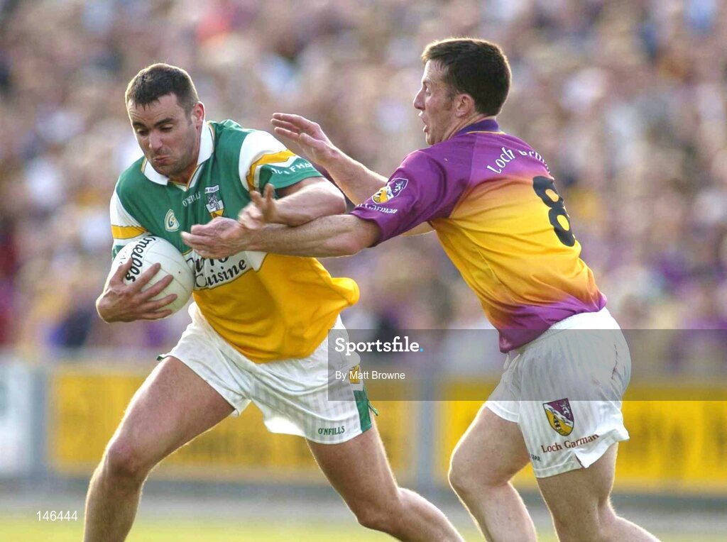 10 July 2004; James Grennan, Offaly, is tackled by Paddy Colfer, Wexford. Bank of Ireland Senior Football Championship Qualifier, Round 2, Wexford v Offaly, Wexford Park, Wexford. Picture credit; Matt Browne / SPORTSFILE