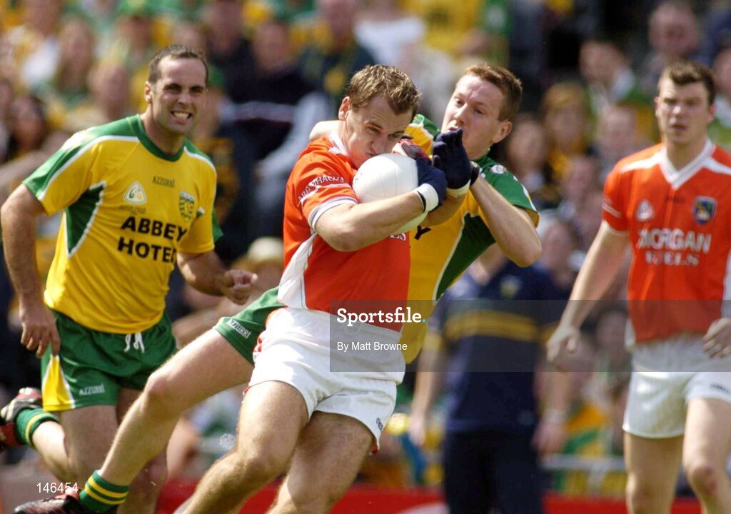 11 July 2004; Paddy McKeever, Armagh, is tackled by Raymond Sweeney, Donegal. Bank of Ireland Ulster Senior Football Championship Final, Armagh v Donegal, Croke Park, Dublin. Picture credit; Matt Browne / SPORTSFILE