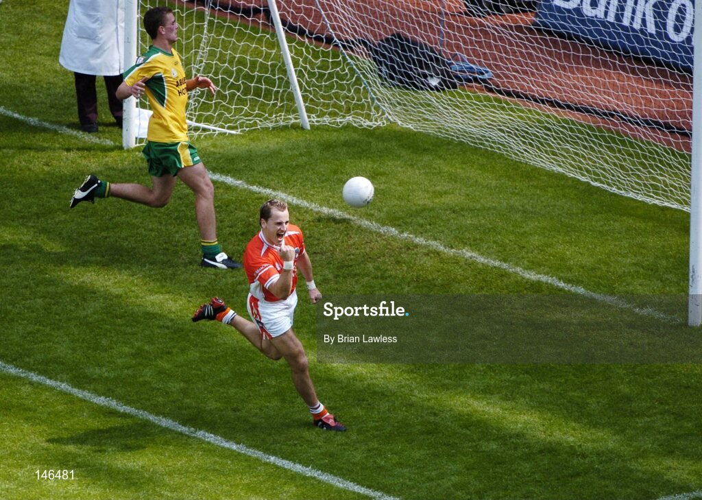 11 July 2004; Armagh's Paddy McKeever celebrates after scoring his sides second goal as Donegal's Eamon McGee looks on. Bank of Ireland Ulster Senior Football Championship Final, Armagh v Donegal, Croke Park, Dublin. Picture credit; Brian Lawless / SPORTSFILE