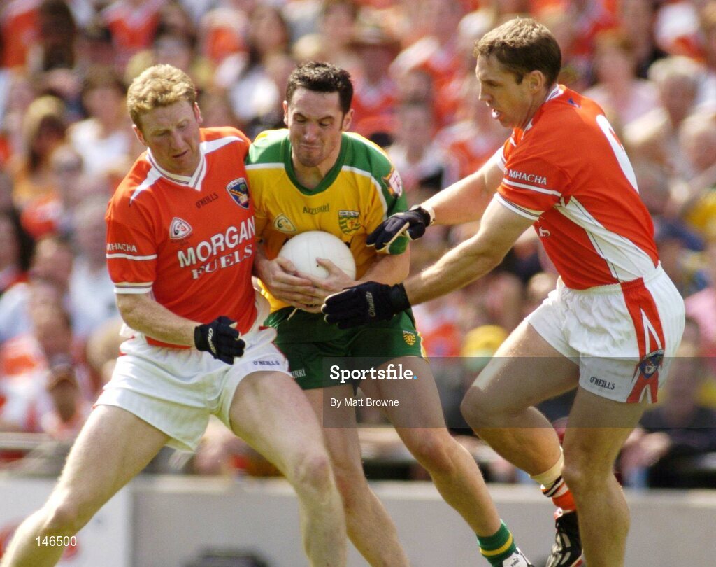 11 July 2004; Brendan Devenney, Donegal, is tackled by Francie Bellew,left, and Kieran McGeeney, Armagh. Bank of Ireland Ulster Senior Football Championship Final, Armagh v Donegal, Croke Park, Dublin. Picture credit; Matt Browne / SPORTSFILE