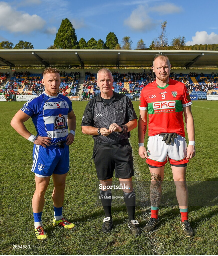 22 October 2023; Referee Keron Kenny with Kevin Hanlon captain of Blessington and Theo Smyth captain of Rathnew before the Wicklow County Senior Club Football Championship final between Blessington and Rathnew at Echelon Park in Aughrim, Wicklow. Photo by Matt Browne/Sportsfile