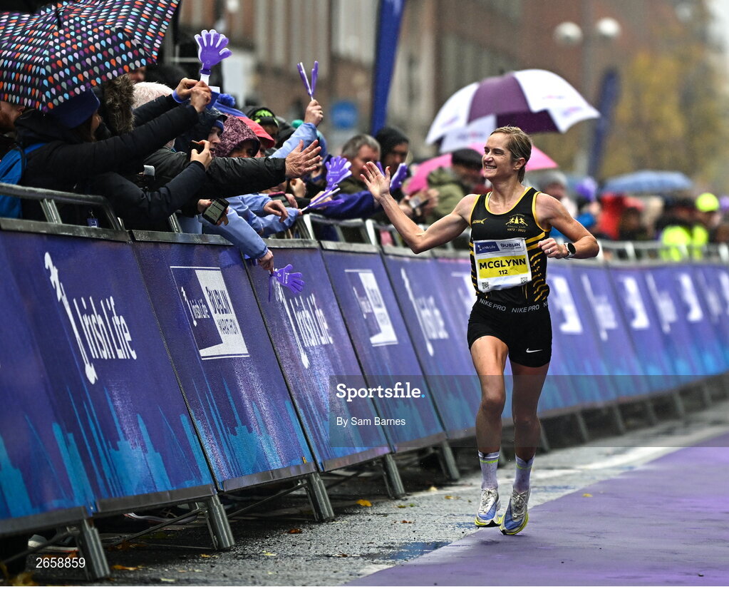 29 October 2023; Irish Women's National Champion Ann-Marie McGlynn celebrates as she crosses the finish line during the 2023 Irish Life Dublin Marathon. Thousands of runners took to the Fitzwilliam Square start line, to participate in the 42nd running of the Dublin Marathon. Photo by Sam Barnes/Sportsfile