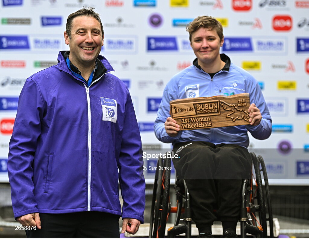 29 October 2023; Irish Life CEO Declan Bolger, left, with Claudia Burrough who became the 2023 Irish Life Dublin Marathon champion of the women's wheelchair race. Thousands of runners took to the Fitzwilliam Square start line, to participate in the 42nd running of the Dublin Marathon. Photo by Sam Barnes/Sportsfile