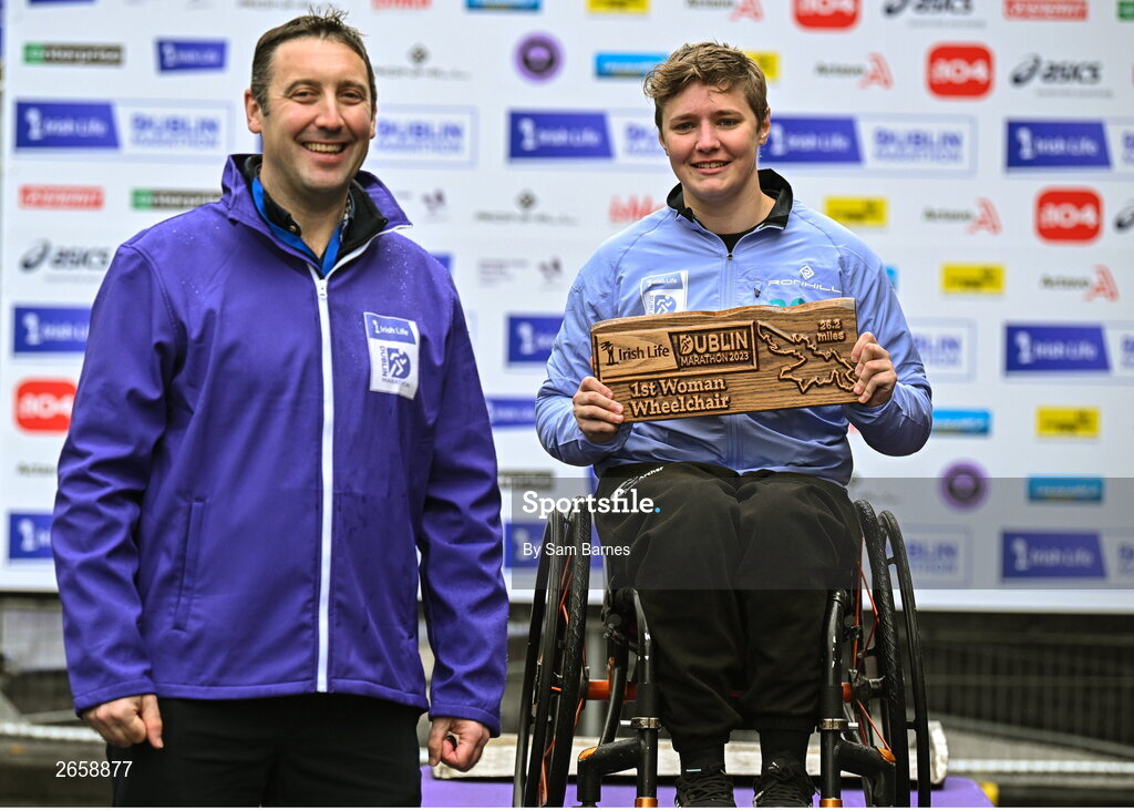 29 October 2023; Irish Life CEO Declan Bolger, left, with Claudia Burrough who became the 2023 Irish Life Dublin Marathon champion of the women's wheelchair race. Thousands of runners took to the Fitzwilliam Square start line, to participate in the 42nd running of the Dublin Marathon. Photo by Sam Barnes/Sportsfile