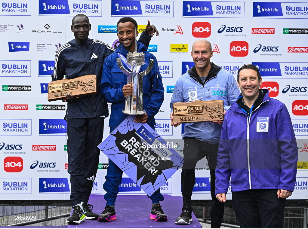 29 October 2023; The Men's event podium, from left, second place Geofrey Kusuro, first place Kemal Husen, and third place Stephen Scullion with Irish Life CEO Declan Bolger after the 2023 Irish Life Dublin Marathon. Thousands of runners took to the Fitzwilliam Square start line, to participate in the 42nd running of the Dublin Marathon. Photo by Sam Barnes/Sportsfile