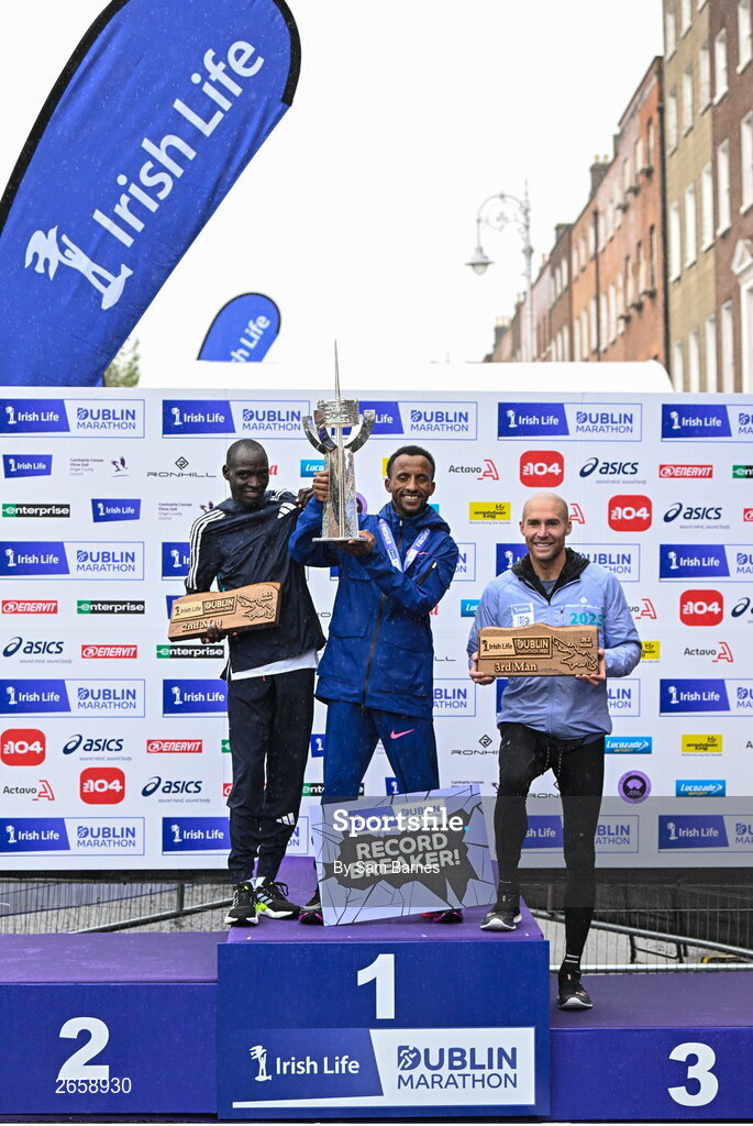 29 October 2023; The Men's event podium, from left, second place Geofrey Kusuro, first place Kemal Husen, and third place Stephen Scullion after the 2023 Irish Life Dublin Marathon. Thousands of runners took to the Fitzwilliam Square start line, to participate in the 42nd running of the Dublin Marathon. Photo by Sam Barnes/Sportsfile
