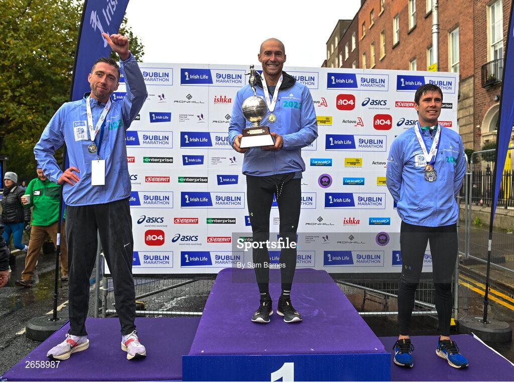 29 October 2023; Men's National Championship podium, from left, second place Ryan Creech from Cork, first place Stephen Scullion, and third place Ryan Forsyth from Tipperary, during the 2023 Irish Life Dublin Marathon. Thousands of runners took to the Fitzwilliam Square start line, to participate in the 42nd running of the Dublin Marathon. Photo by Sam Barnes/Sportsfile