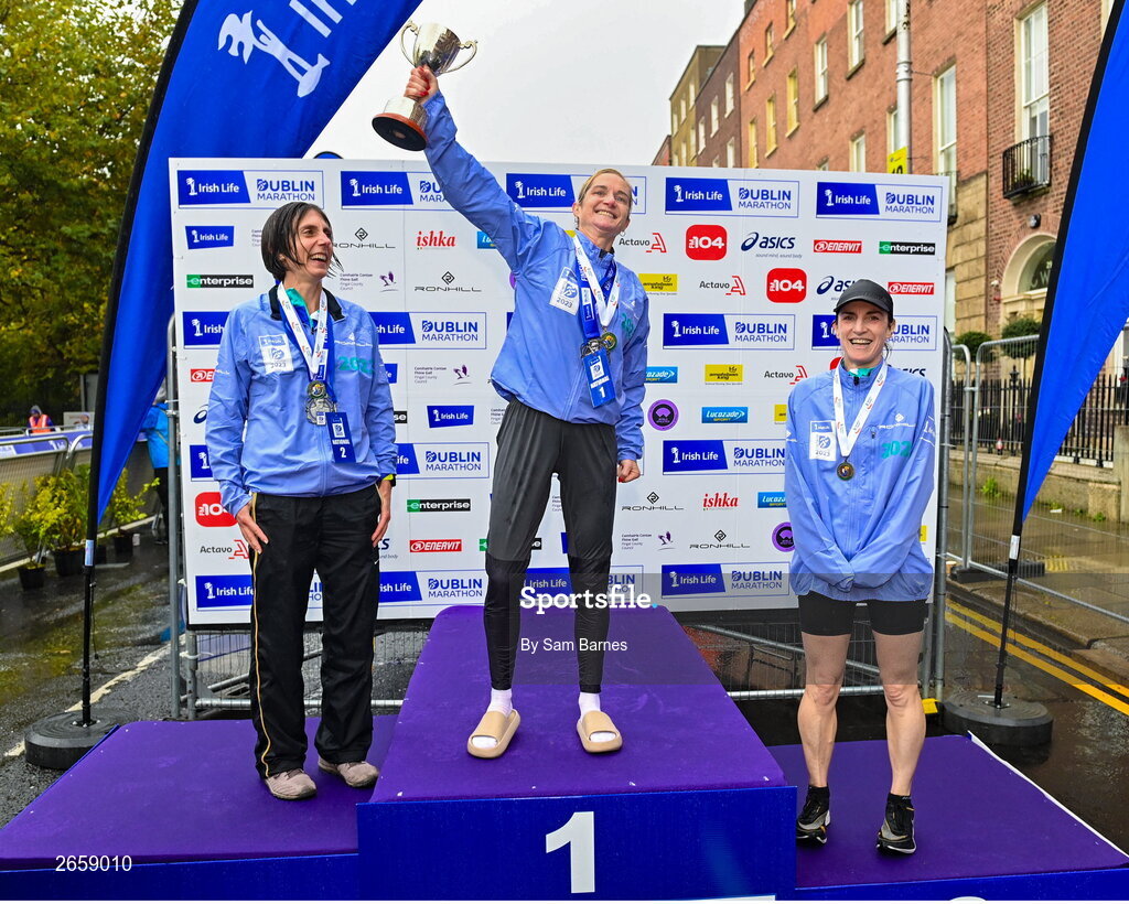 29 October 2023; Women's National Championship podium, from left, second place Gladys Ganiel, first place Ann-Marie Mc Glynn, and third place Sorcha Loughnane from Dublin, after the 2023 Irish Life Dublin Marathon. Thousands of runners took to the Fitzwilliam Square start line, to participate in the 42nd running of the Dublin Marathon. Photo by Sam Barnes/Sportsfile