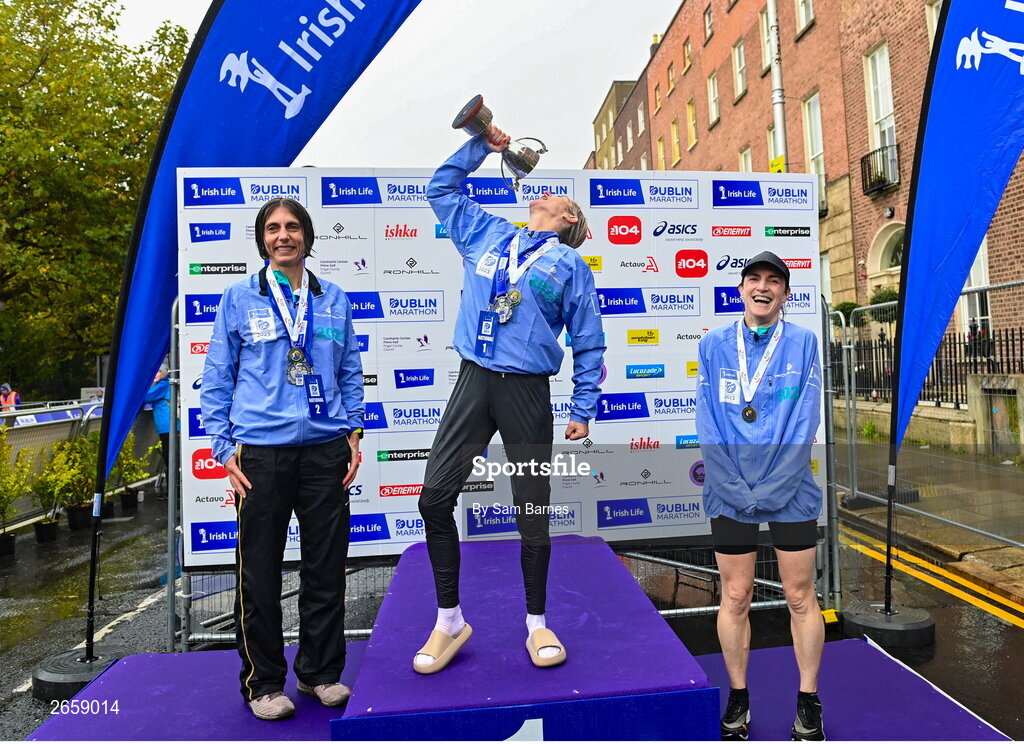 29 October 2023; Women's National Championship podium, from left, second place Gladys Ganiel, first place Ann-Marie Mc Glynn, and third place Sorcha Loughnane from Dublin, after the 2023 Irish Life Dublin Marathon. Thousands of runners took to the Fitzwilliam Square start line, to participate in the 42nd running of the Dublin Marathon. Photo by Sam Barnes/Sportsfile