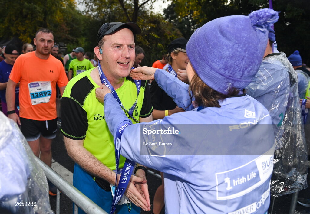 29 October 2023; Participants receive their medals after the 2023 Irish Life Dublin Marathon. Thousands of runners took to the Fitzwilliam Square start line, to participate in the 42nd running of the Dublin Marathon. Photo by Sam Barnes/Sportsfile