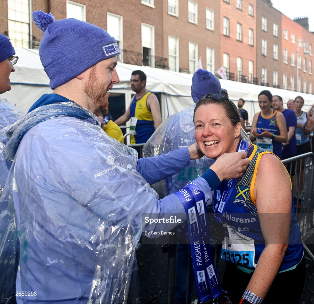 29 October 2023; Aine Crosse from Tipperary receives her medal after the 2023 Irish Life Dublin Marathon. Thousands of runners took to the Fitzwilliam Square start line, to participate in the 42nd running of the Dublin Marathon. Photo by Sam Barnes/Sportsfile