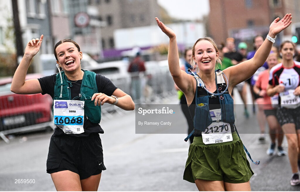 29 October 2023; Siofra Macelhatton, left, and Jessica McCleery, from Antrim, during the 2023 Irish Life Dublin Marathon. Thousands of runners took to the Fitzwilliam Square start line, to participate in the 42nd running of the Dublin Marathon. Photo by Ramsey Cardy/Sportsfile