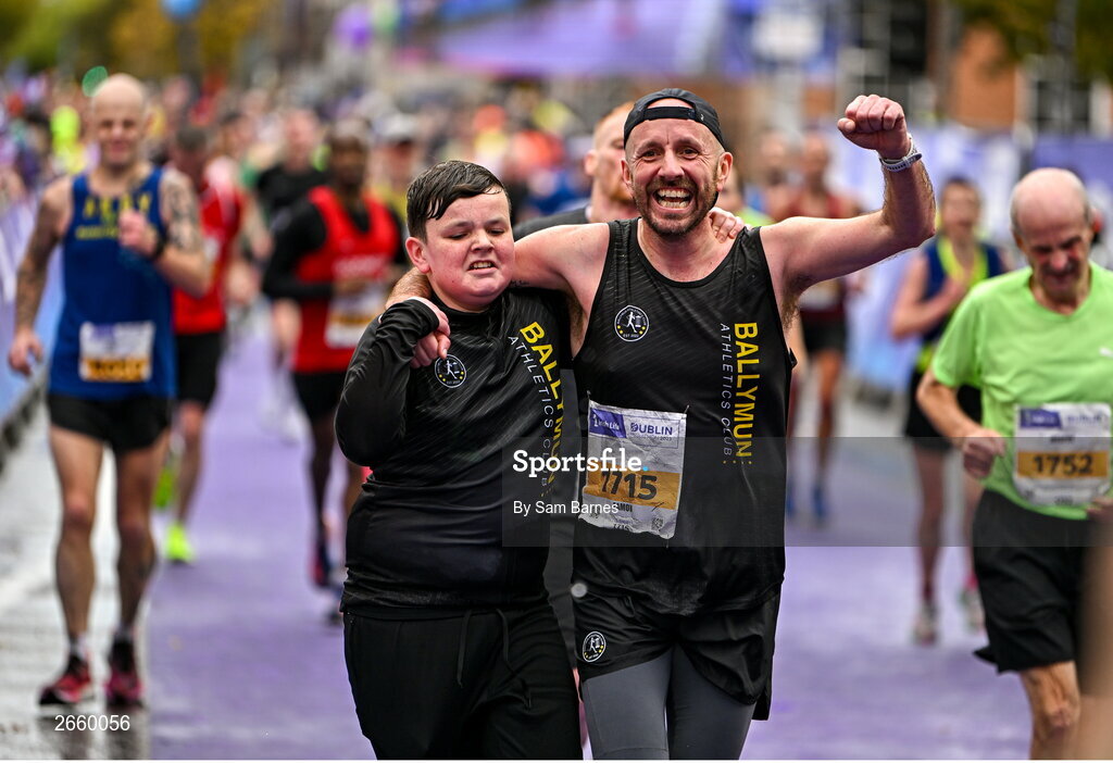 29 October 2023; Eamon Carthy from Dublin 11, crosses the line with his son Cian, after running the 2023 Irish Life Dublin Marathon. Thousands of runners took to the Fitzwilliam Square start line, to participate in the 42nd running of the Dublin Marathon. Photo by Sam Barnes/Sportsfile