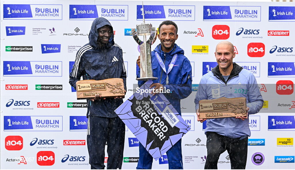 29 October 2023; The Men's event podium, from left, second place Geofrey Kusuro, first place Kemal Husen, and third place Stephen Scullion  after the 2023 Irish Life Dublin Marathon. Thousands of runners took to the Fitzwilliam Square start line, to participate in the 42nd running of the Dublin Marathon. Photo by Sam Barnes/Sportsfile