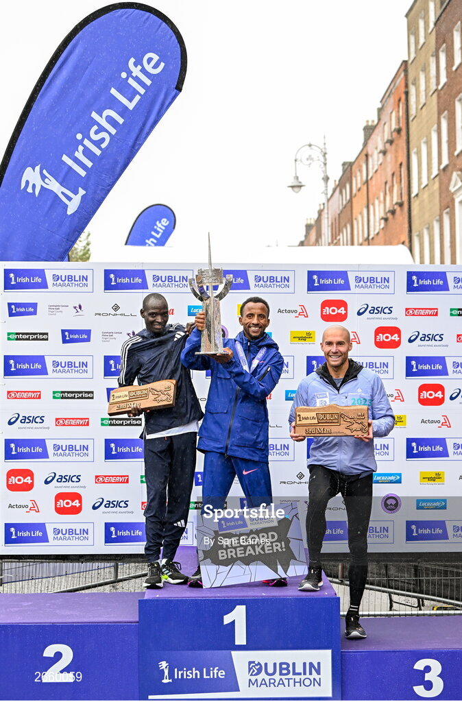 29 October 2023; The Men's event podium, from left, second place Geofrey Kusuro, first place Kemal Husen, and third place Stephen Scullion  after the 2023 Irish Life Dublin Marathon. Thousands of runners took to the Fitzwilliam Square start line, to participate in the 42nd running of the Dublin Marathon. Photo by Sam Barnes/Sportsfile