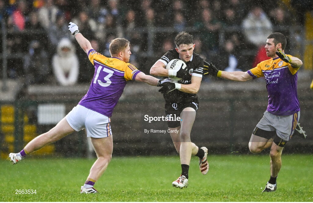 5 November 2023; Miceal Rooney of Kilcoo in action against Leigh Jones, left, and Michael Jones of Derrygonnelly Harps during the AIB Ulster GAA Football Senior Club Championship round 1 match between Derrygonnelly Harps of Fermanagh and Kilcoo of Down at Brewster Park in Enniskillen, Fermanagh. Photo by Ramsey Cardy/Sportsfile