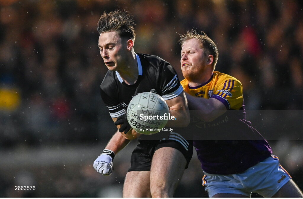 5 November 2023; Ceilum Doherty of Kilcoo is tackled by Leigh Jones of Derrygonnelly Harps  during the AIB Ulster GAA Football Senior Club Championship round 1 match between Derrygonnelly Harps of Fermanagh and Kilcoo of Down at Brewster Park in Enniskillen, Fermanagh. Photo by Ramsey Cardy/Sportsfile